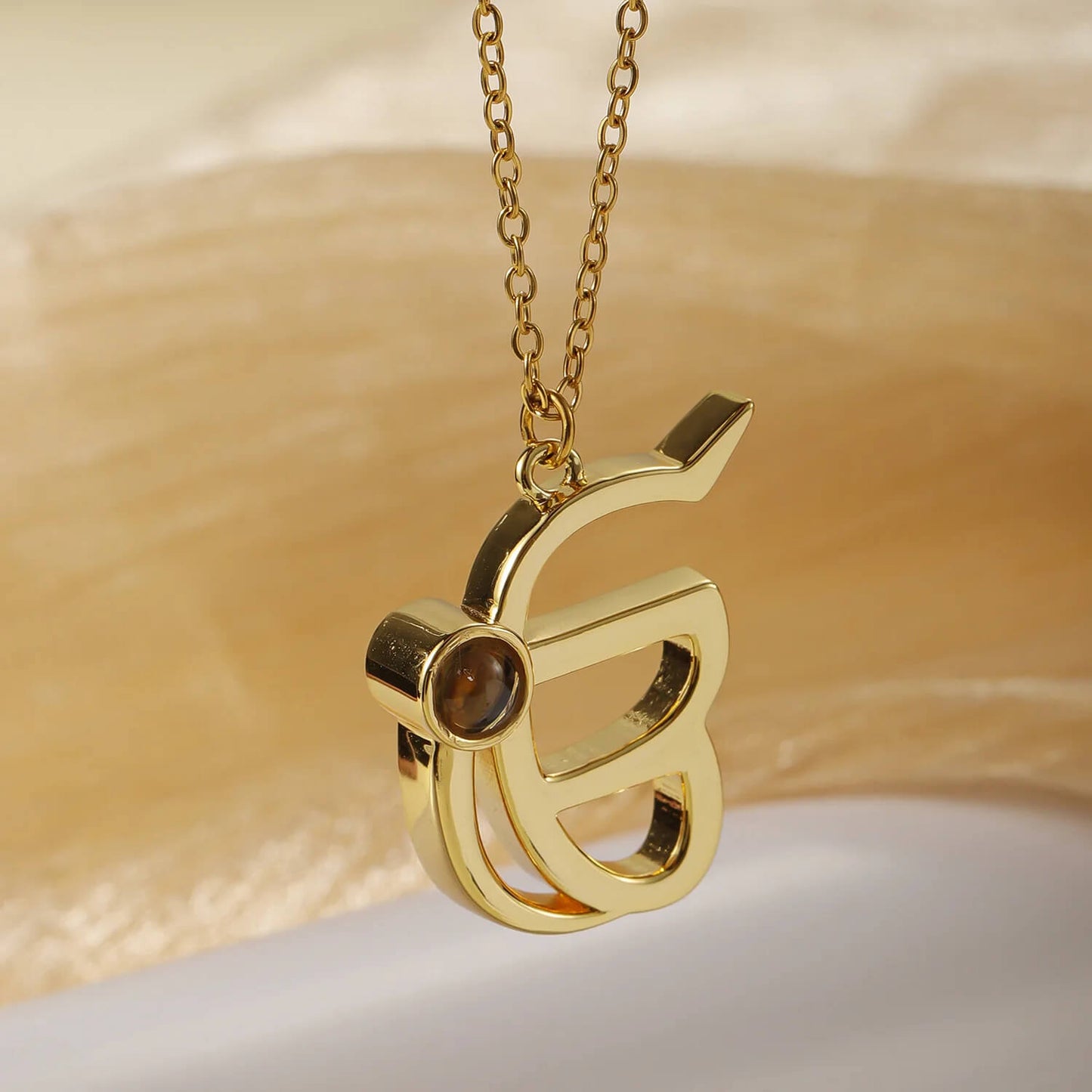 Angled view of gold 3D Punjabi Projection Necklace pendant, showcasing its 3D structure and photo projection lens.