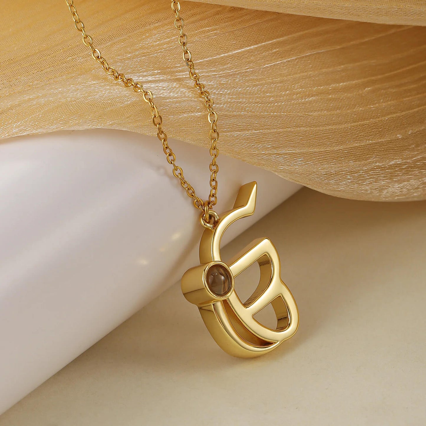 Gold 3D Punjabi Projection Necklace laid flat, highlighting the intricate pendant design and custom photo feature.