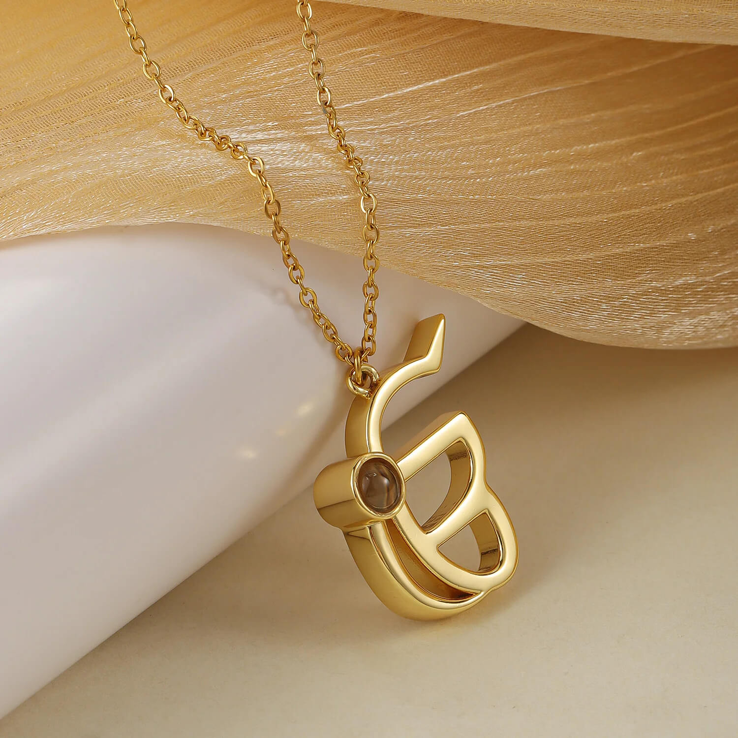 Gold 3D Punjabi Projection Necklace laid flat, highlighting the intricate pendant design and custom photo feature.