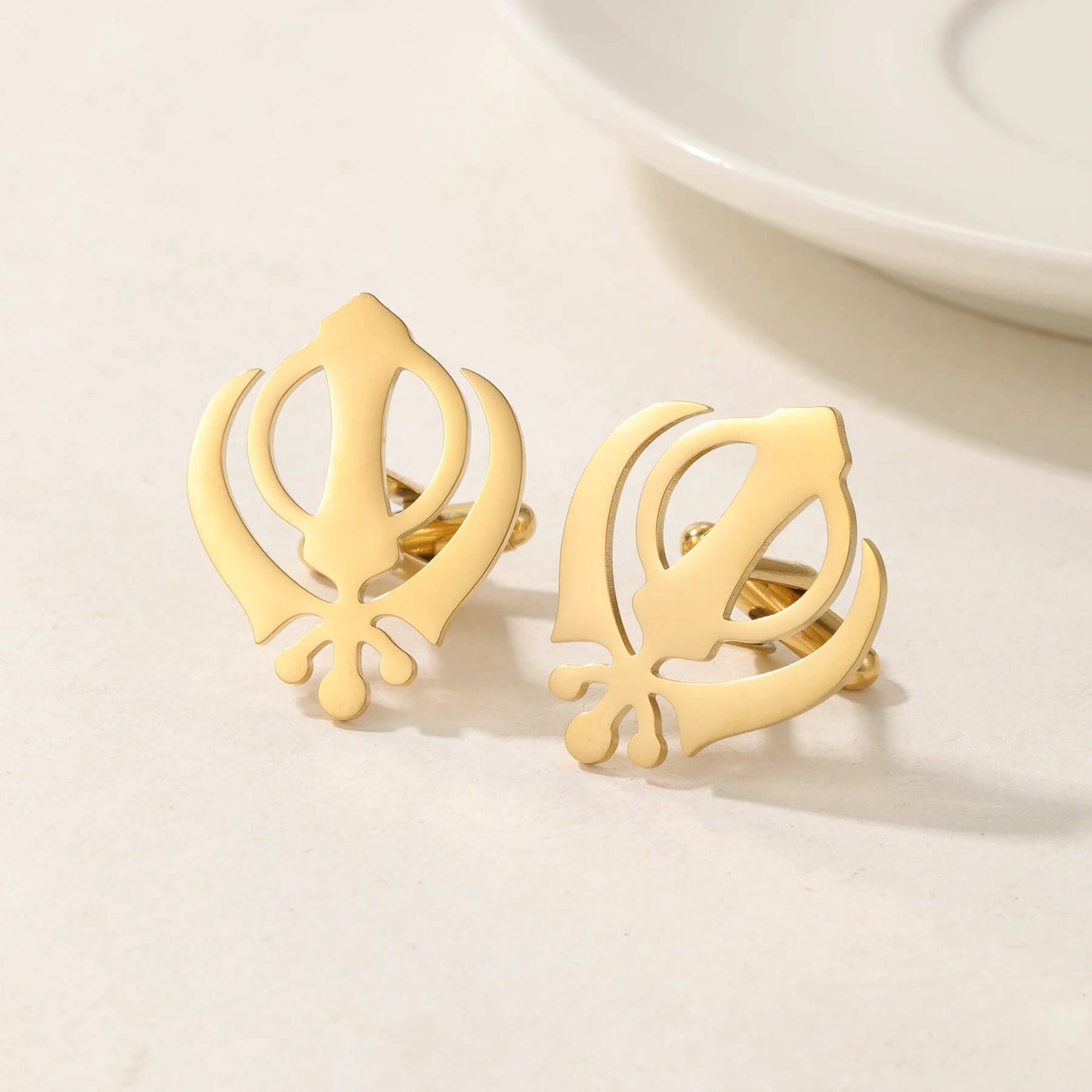 18K gold Punjabi Sikh cufflinks with Khanda symbol, displayed on a white surface for elegant men's accessory appeal.