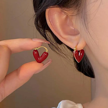 Vintage-inspired Antique Love Hearts Hoops with red enamel heart charms, showcased in elegant style.