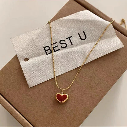 Ruby Glow Heart Necklace featuring a red heart pendant on a gold-tone chain with a 'BEST U' tag.