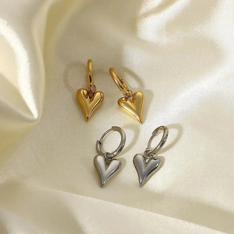 Chic Heart Hoop Earrings in gold and silver on soft satin background, displaying modern elegance and lightweight design.