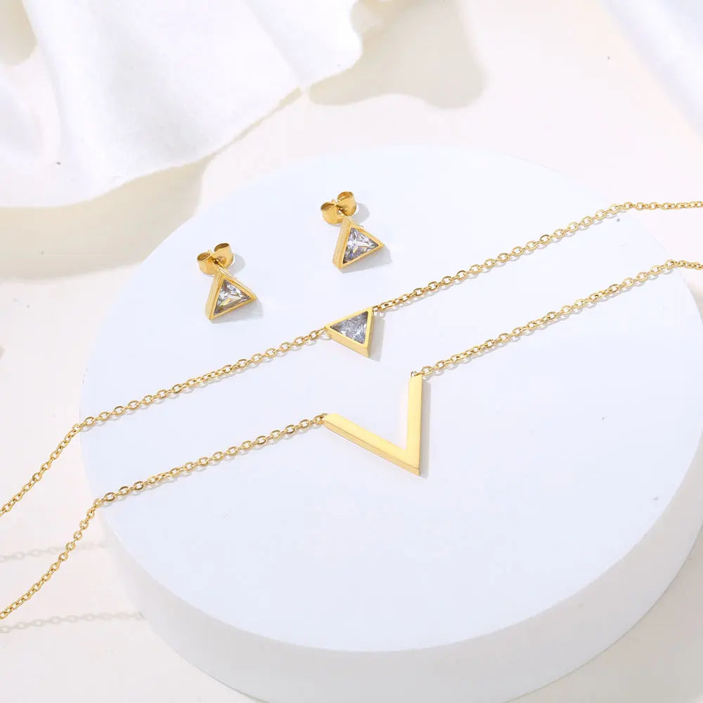 Velora V Set: Geometric pendant necklace and matching earrings in 18k gold PVD plated stainless steel.