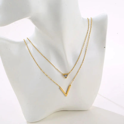 Velora V Set: elegant gold geometric pendant necklace on display, featuring modern minimalist design.