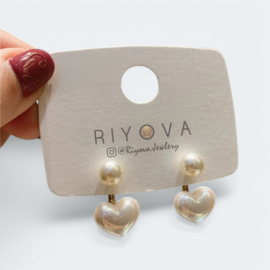 Dainty Love Studs Earrings with heart-shaped design and imitation pearls on display.