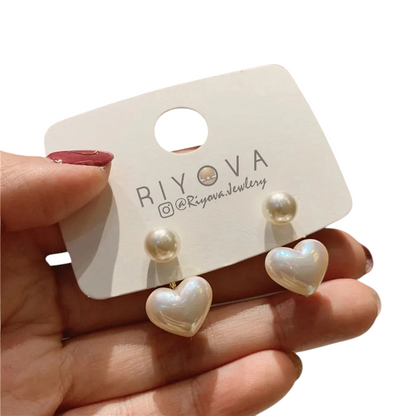 Dainty Love Studs earrings with heart-shaped design and imitation pearls, elegant jewelry for romantic occasions.