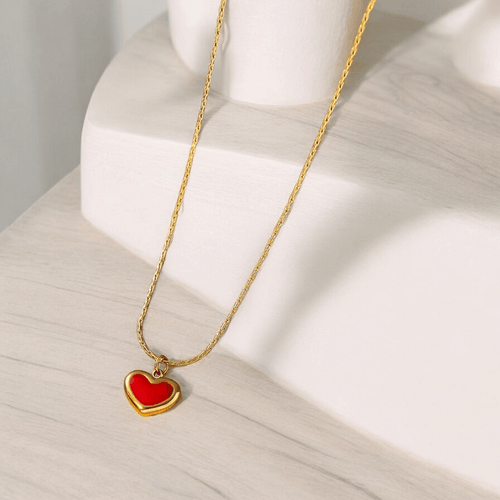 Ruby Glow Heart Necklace featuring a red heart pendant on a gold-tone chain, elegant and romantic jewelry.