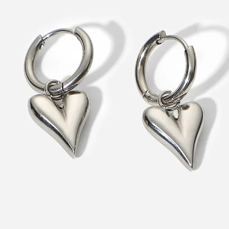 Chic Heart Hoop Earrings with polished heart-shaped pendants, crafted in stainless steel and 18K gold plating.